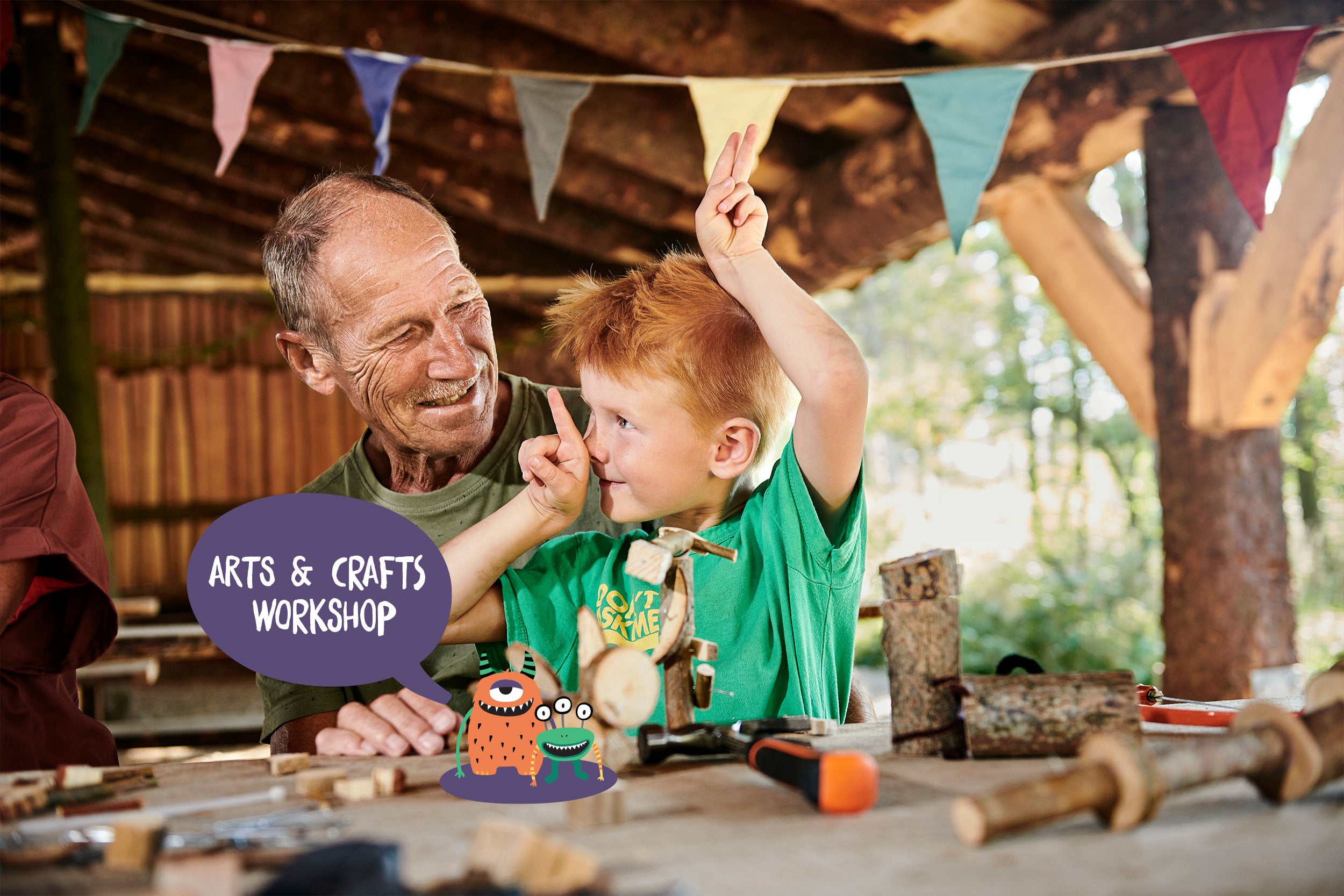 A grandfather and grandchild are busy making crafts in WOW PARK.