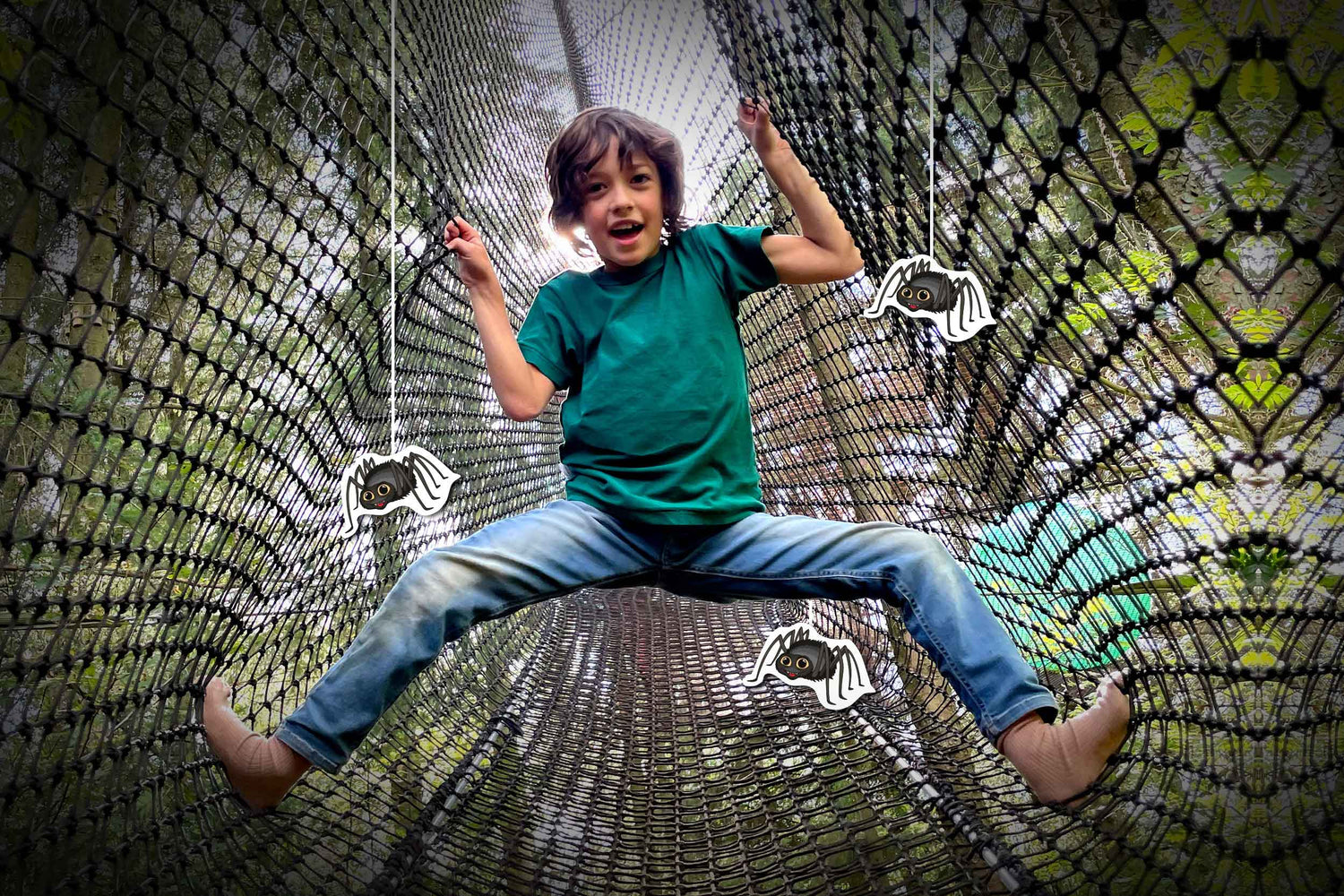 A boy in a large net, holding on with his arms and legs. In front of him, three spiders are attached.