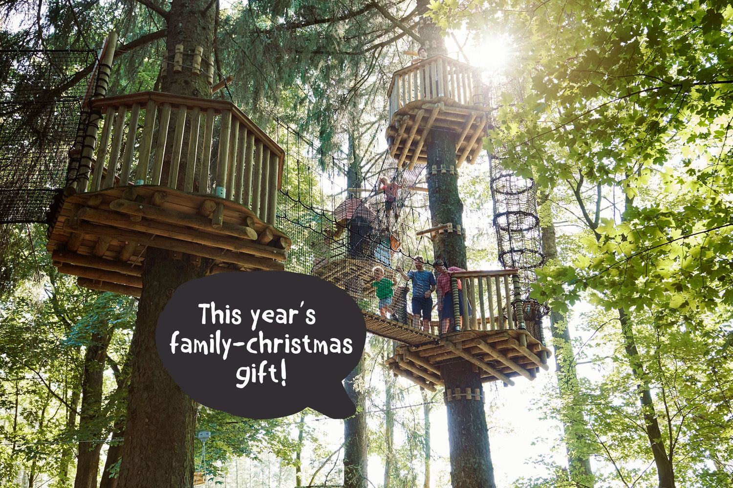 Guests at WOW PARK Billund walk high up in the trees on rope bridges between the treehouses.
