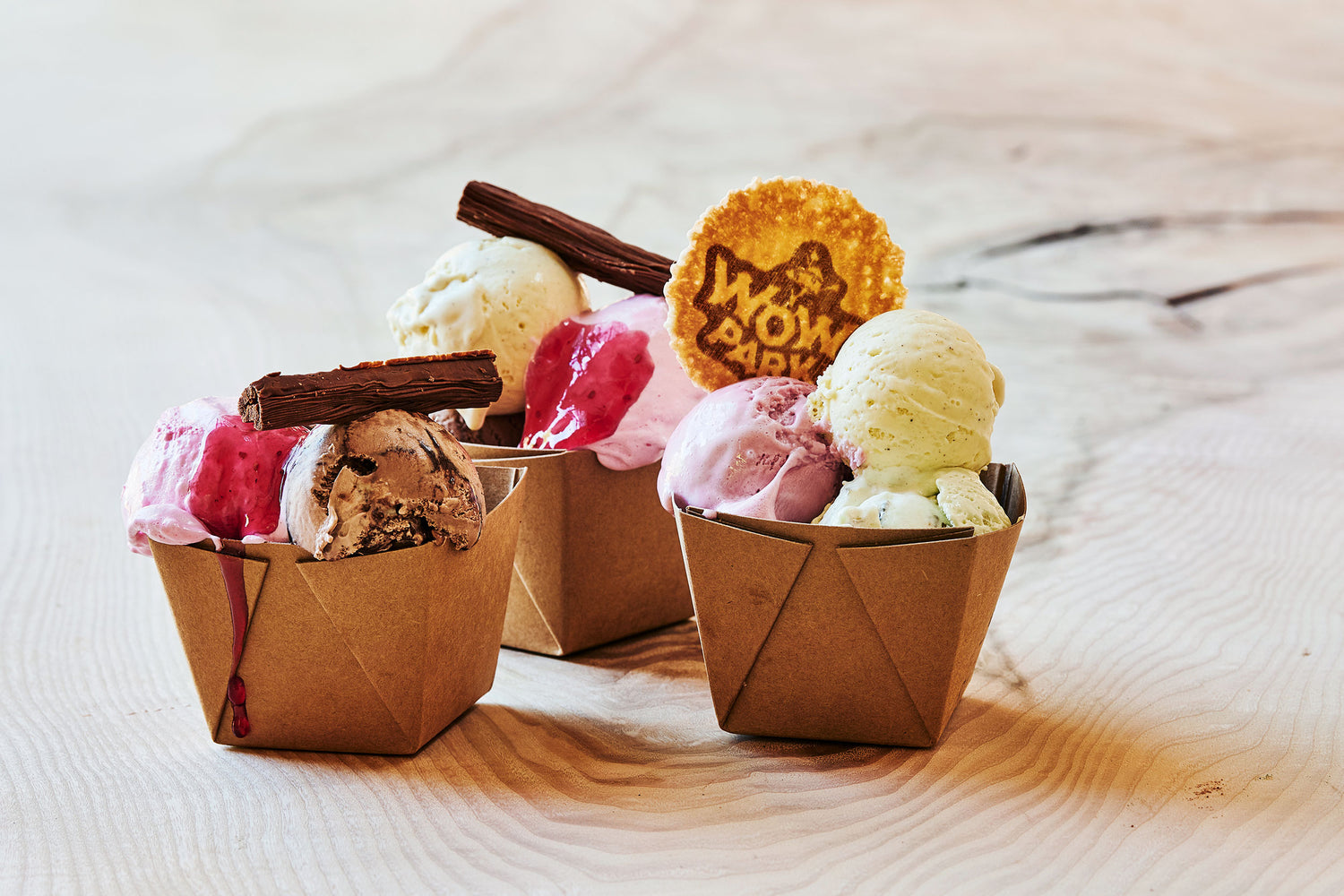 A variety of delicious ice cream served in cups.