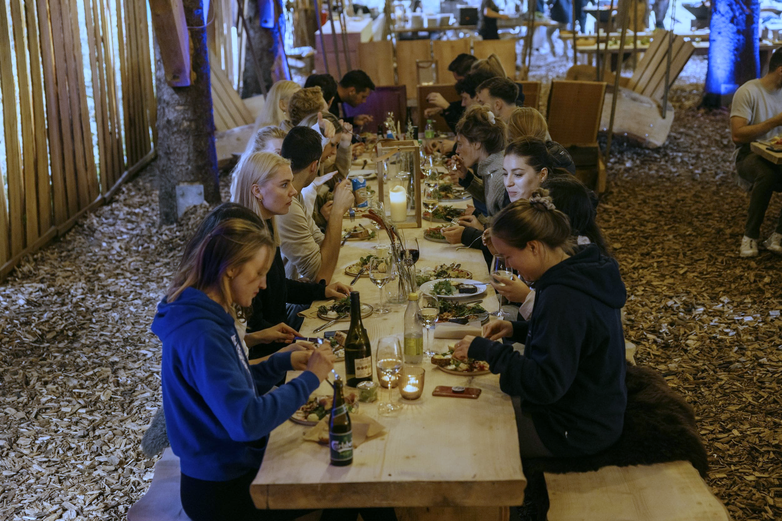 A long table with people enjoying themselves and eating at a team event in WOW PARK.