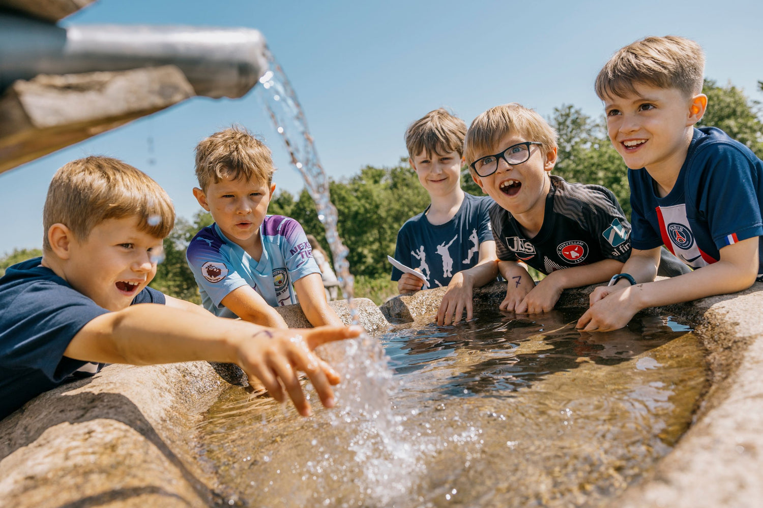 A group of boys is playing with water in WOW PARK.