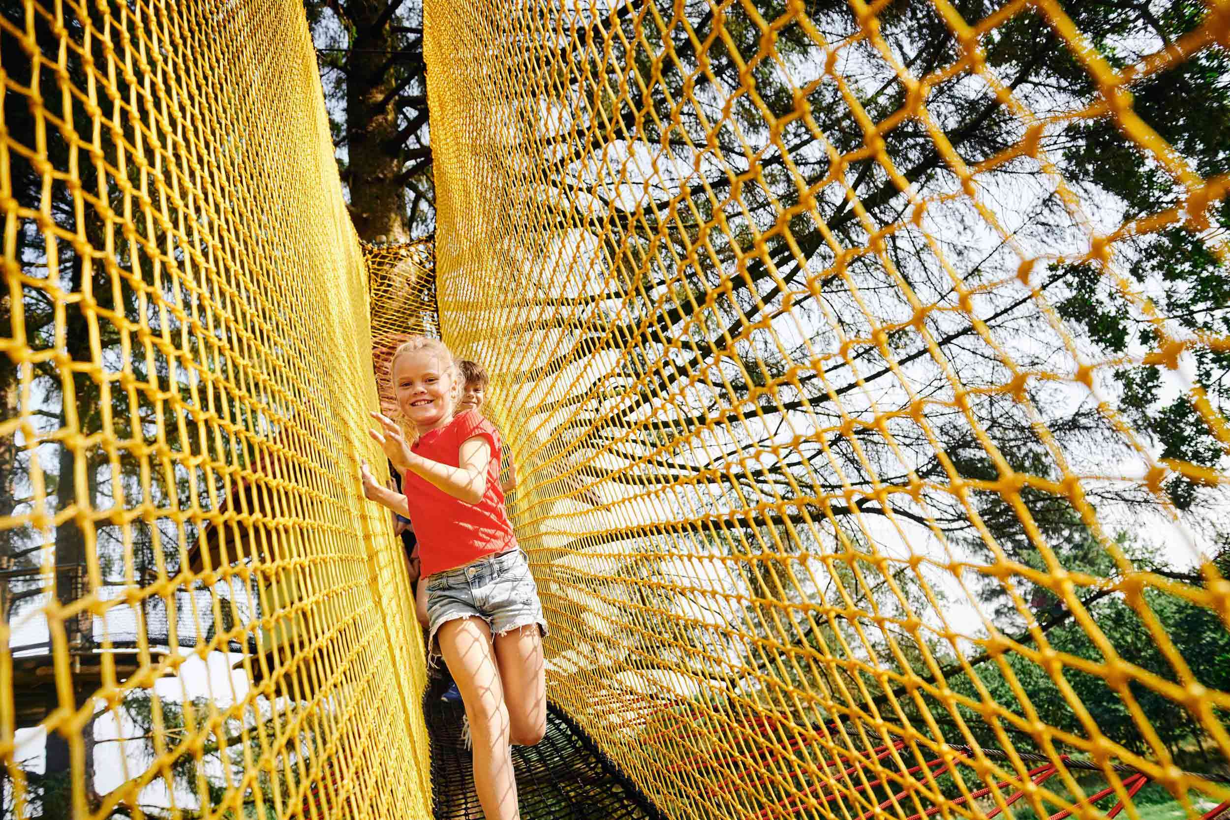 Two children in a yellow net.